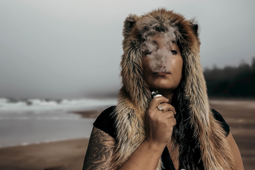 services-img a-man-wearing-a-fur-hat-and-holding-a-cigarette-2rlnaqksio